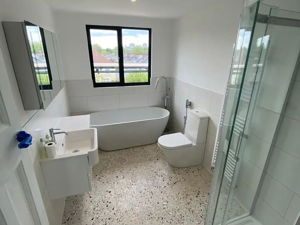 Bright bathroom with freestanding bath after a Bethel clean in London
