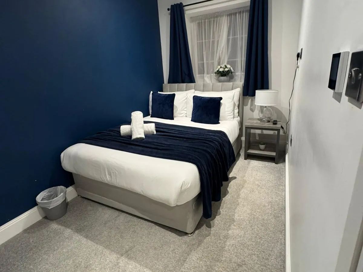 A double bedroom turned around between guests, with fresh linen and towels set out