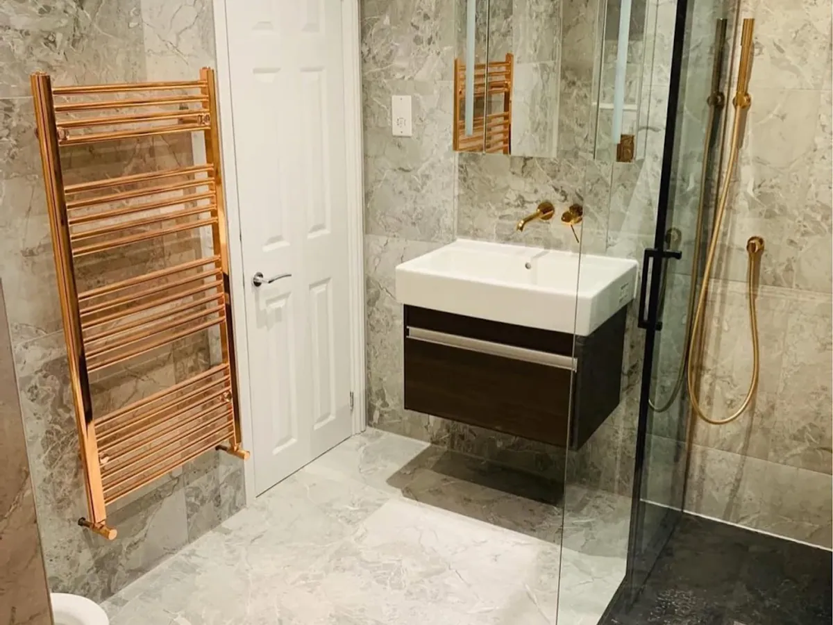 Luxury marble bathroom with copper fittings professionally cleaned in London