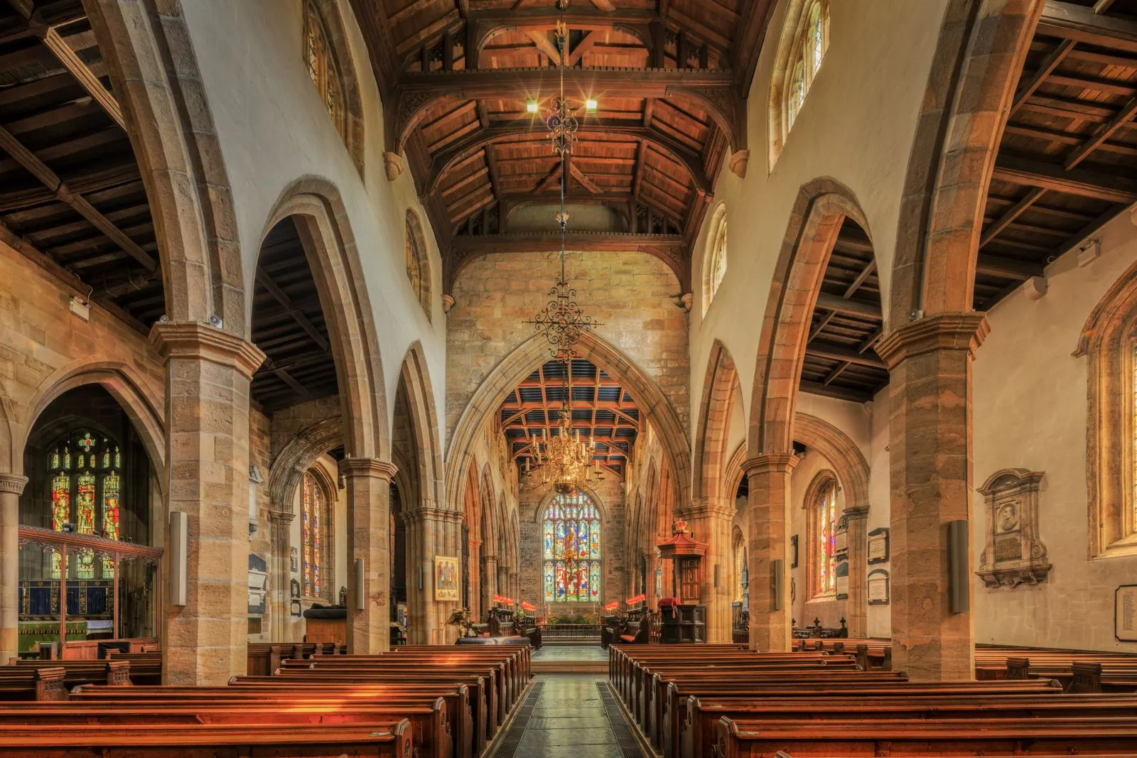Clean church interior with stone arches and pews in London